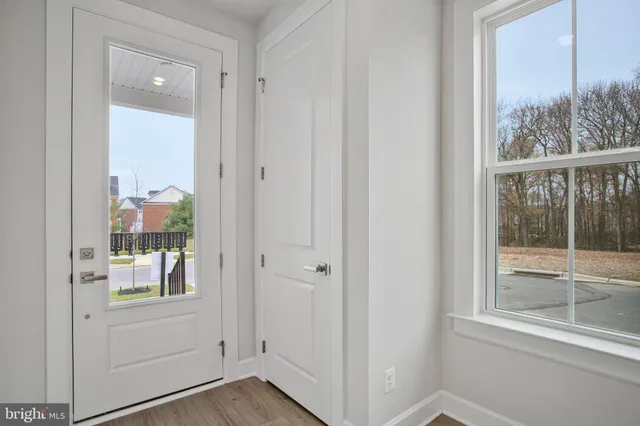 a kitchen that has a lot of cabinets and wooden floor