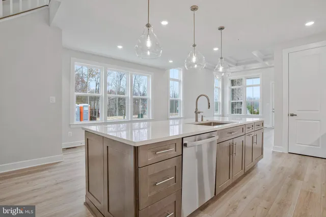 a kitchen with stainless steel appliances a refrigerator and cabinets