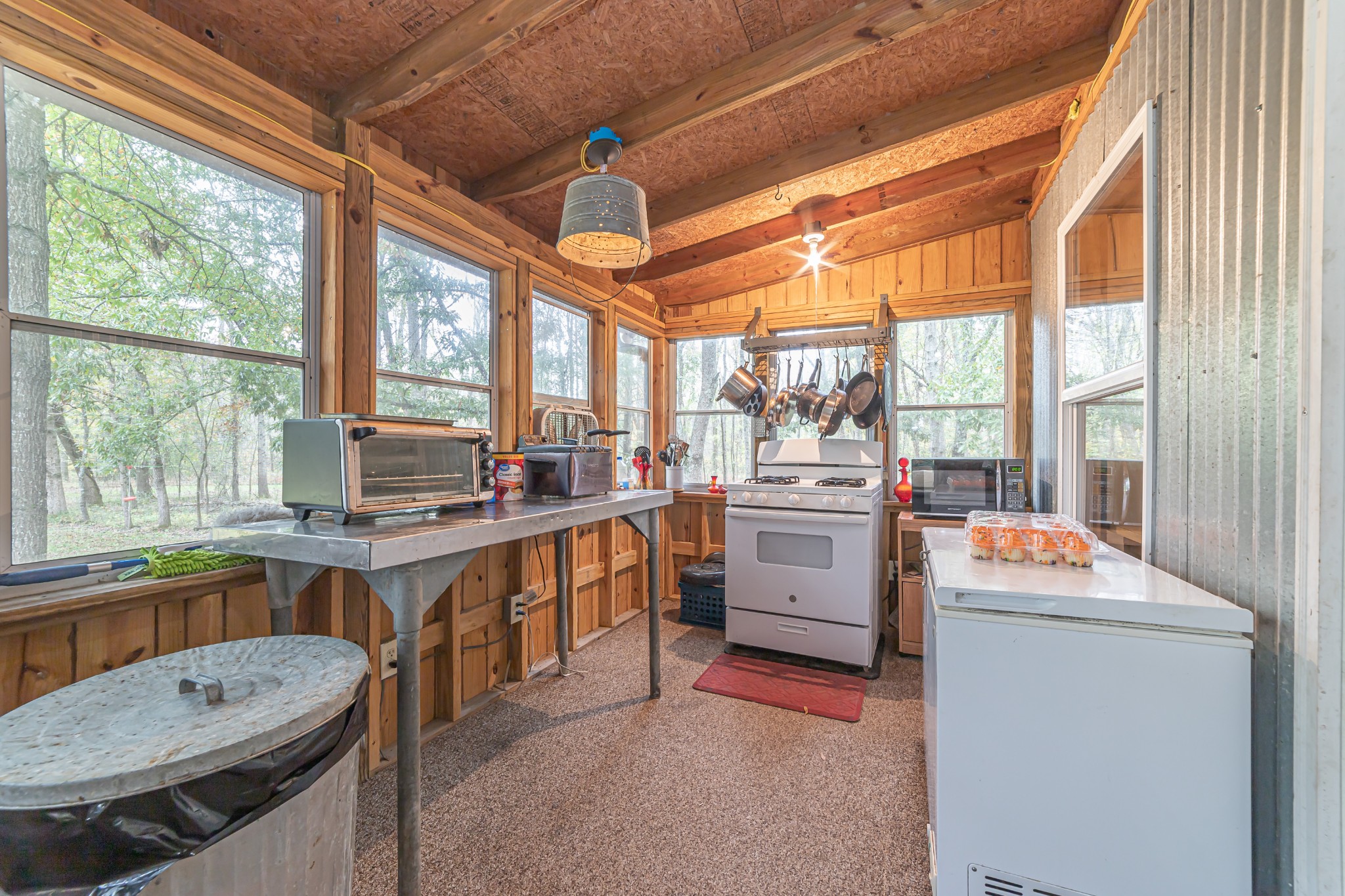 715 Mcgowen Road Morrison, TN 37357 - Photo 11 of 50 a open kitchen with a stove a sink dishwasher and white cabinets with wooden floor