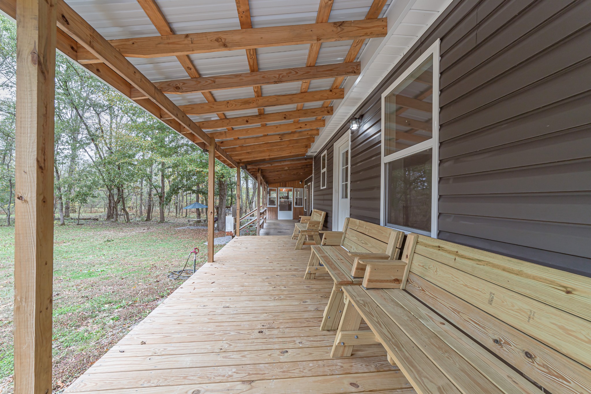 715 Mcgowen Road Morrison, TN 37357 - Photo 34 of 50 a view of a patio with table and chairs with wooden floor and fence