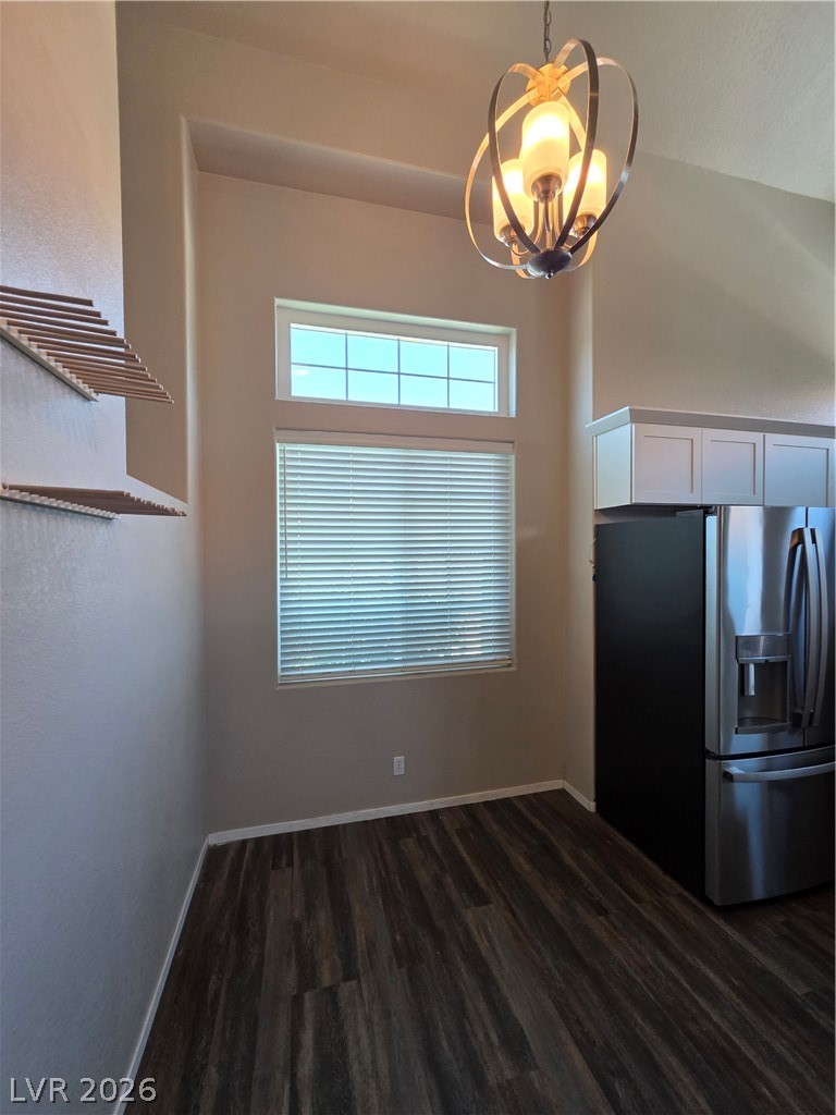 2275 Ramsgate Drive Henderson, NV 89074 - Photo 41 of 84 Illuminated by a modern light fixture, this interior space presents a rich hardwood accent wall and inviting window views.