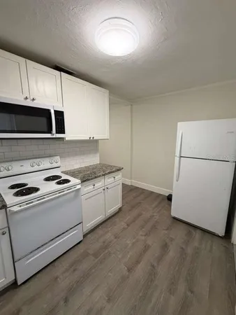 a kitchen with a stove and a microwave