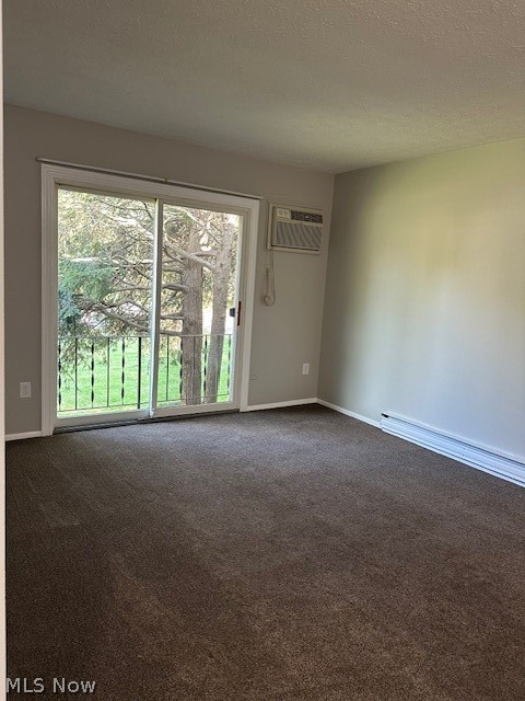 4376 Darrow Road, Unit 7 Stow, OH 44224 - Photo 18 of 23 Empty room featuring carpet, a textured ceiling, and a wall mounted AC