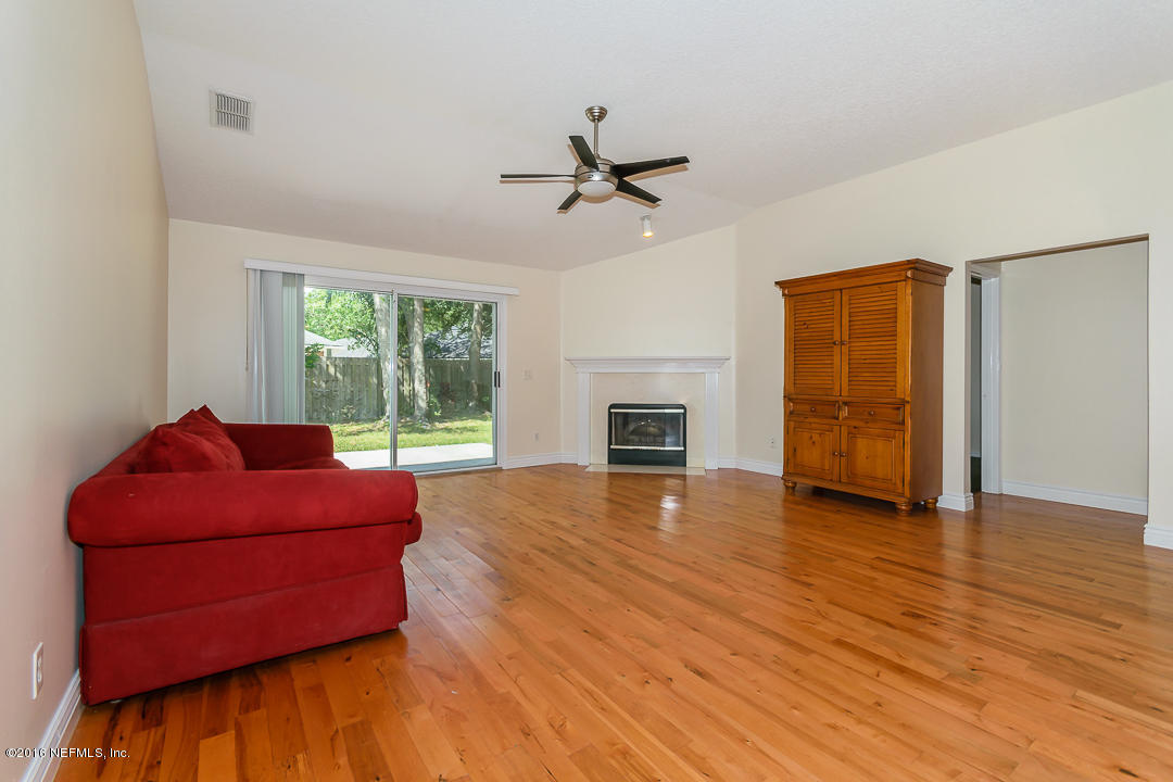 4329 Rye Court St. Johns, FL 32259 - Photo 5 of 25 a living room with furniture and a fireplace