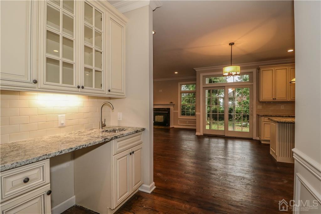 59 Middlesex Avenue Edison, NJ 08820 - Photo 12 of 25 a kitchen with granite countertop a stove a sink and a wooden cabinets