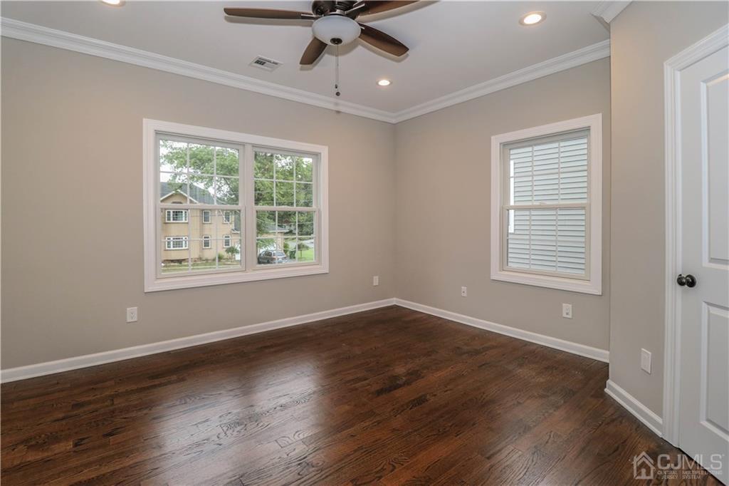 59 Middlesex Avenue Edison, NJ 08820 - Photo 16 of 25 a view of an empty room with wooden floor and a window