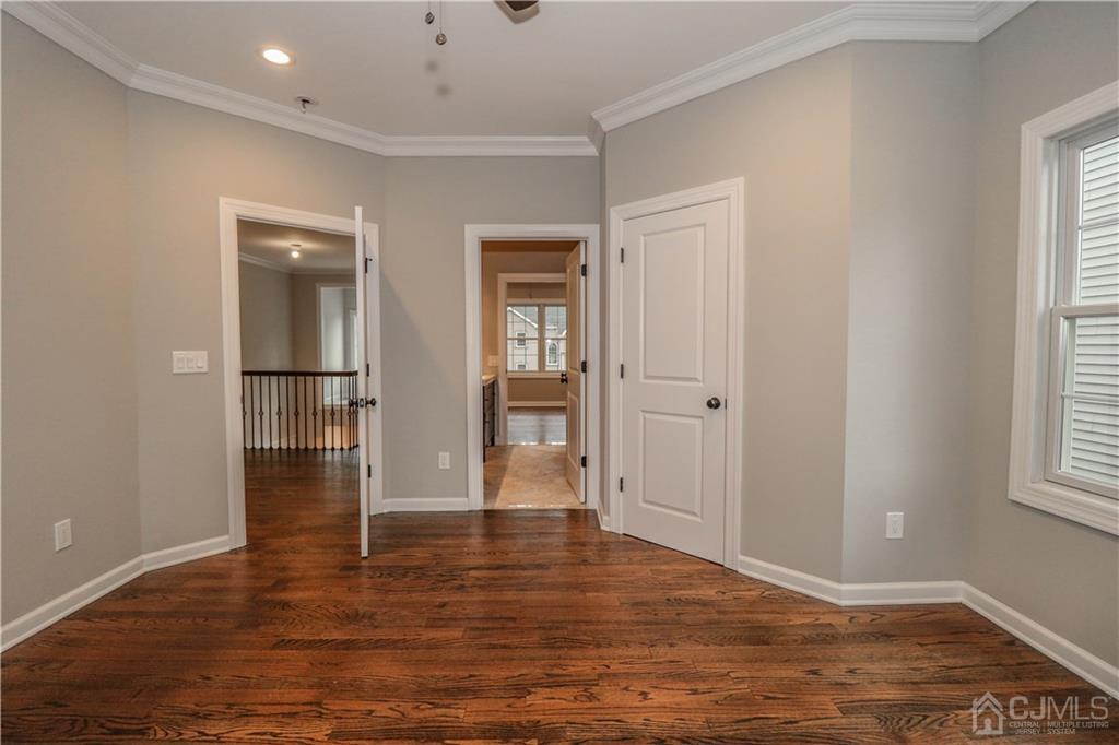 59 Middlesex Avenue Edison, NJ 08820 - Photo 17 of 25 an empty room with wooden floor and windows