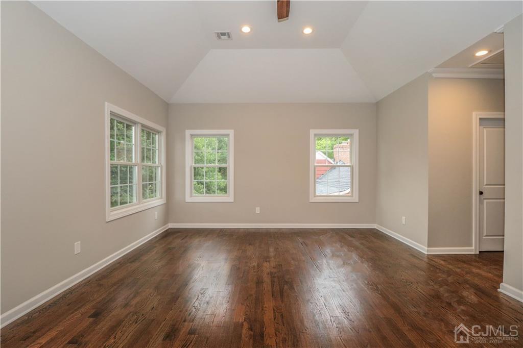 59 Middlesex Avenue Edison, NJ 08820 - Photo 21 of 25 an empty room with wooden floor and windows