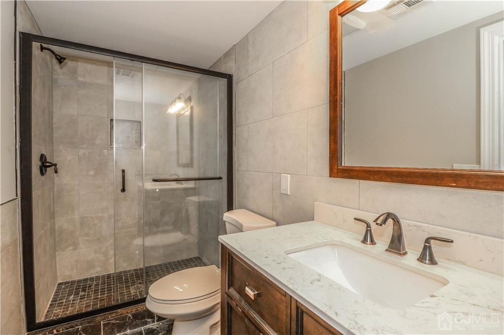 59 Middlesex Avenue Edison, NJ 08820 - Photo 23 of 25 a bathroom with a granite countertop sink toilet and shower