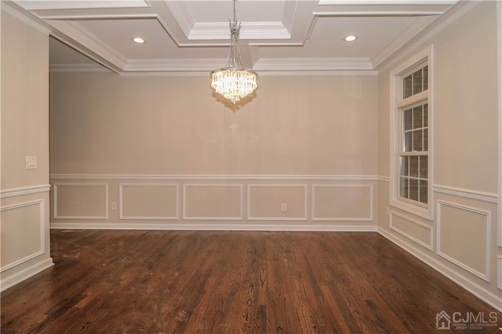 59 Middlesex Avenue Edison, NJ 08820 - Photo 4 of 25 an empty room with wooden floor and windows