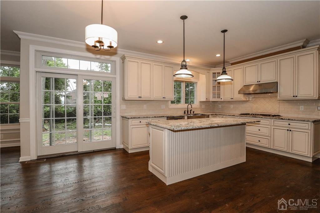 59 Middlesex Avenue Edison, NJ 08820 - Photo 7 of 25 a kitchen with stainless steel appliances granite countertop wooden floors sink and cabinets