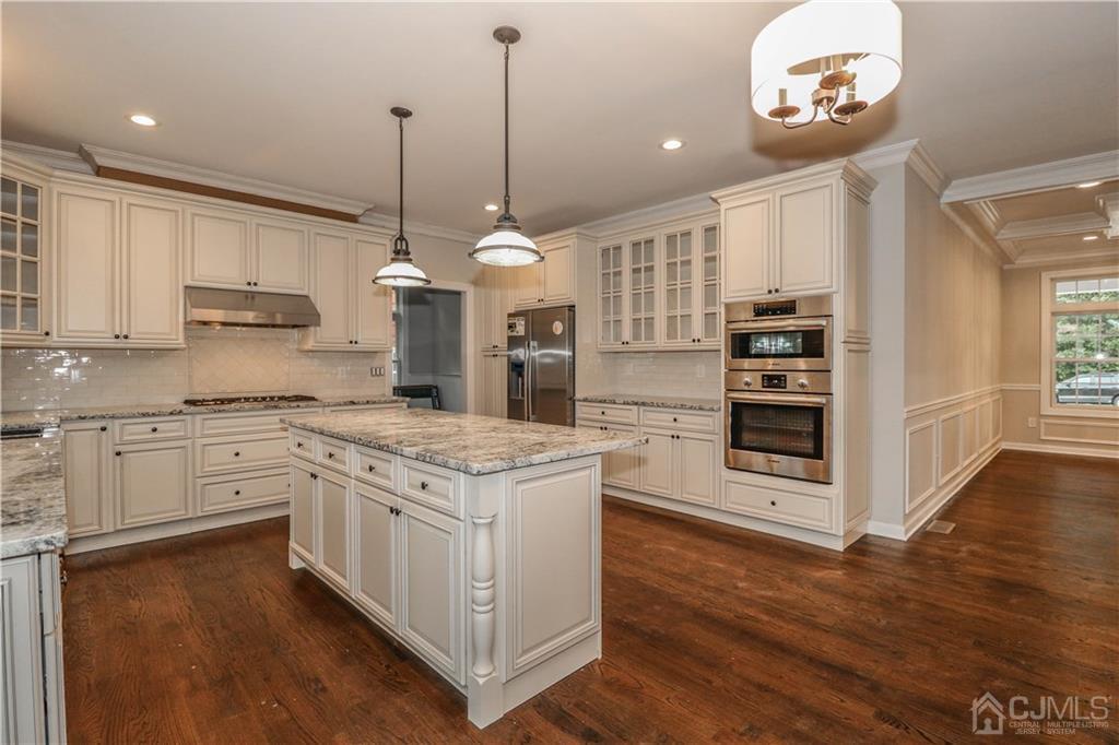 59 Middlesex Avenue Edison, NJ 08820 - Photo 8 of 25 a kitchen with stainless steel appliances granite countertop a stove a sink and a wooden floor