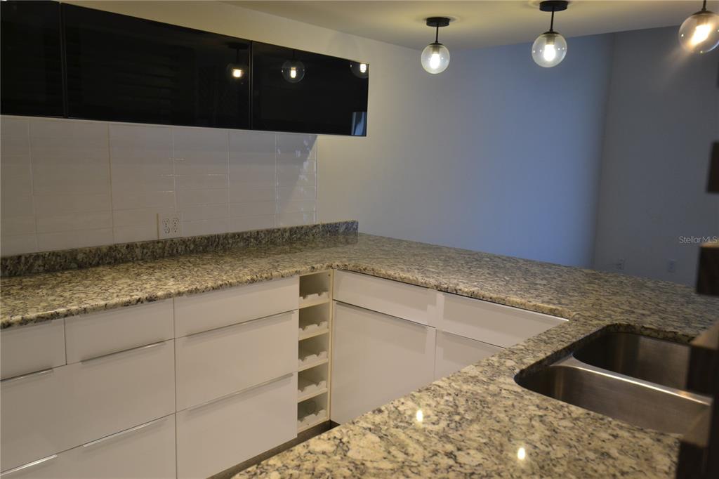 2585 Countryside Boulevard, Unit 4307 Clearwater, FL 33761 - Photo 11 of 32 a kitchen with a sink and cabinets