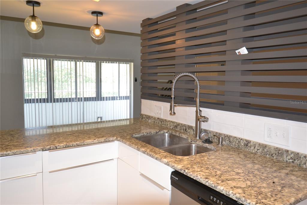 2585 Countryside Boulevard, Unit 4307 Clearwater, FL 33761 - Photo 12 of 32 a kitchen with a sink and a window
