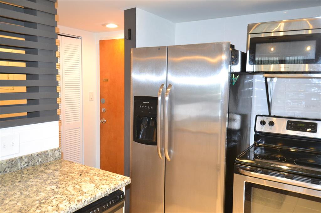 2585 Countryside Boulevard, Unit 4307 Clearwater, FL 33761 - Photo 13 of 32 a kitchen with a refrigerator and a stove