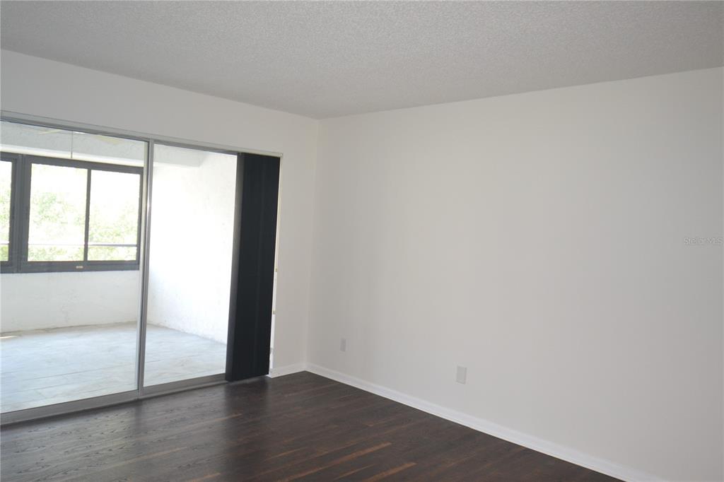 2585 Countryside Boulevard, Unit 4307 Clearwater, FL 33761 - Photo 2 of 32 an empty room with wooden floor and windows