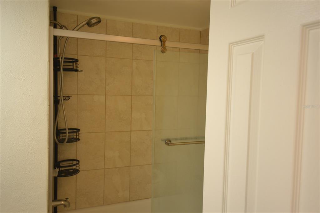 2585 Countryside Boulevard, Unit 4307 Clearwater, FL 33761 - Photo 8 of 32 a bathroom with a shower