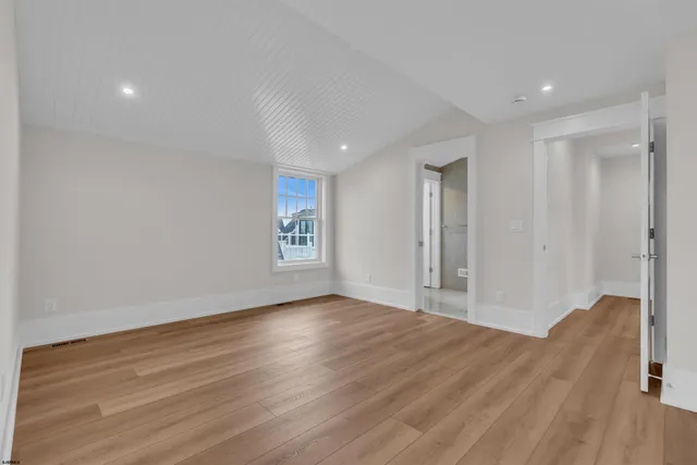 a bathroom with a granite countertop bathtub shower sink vanity and toilet