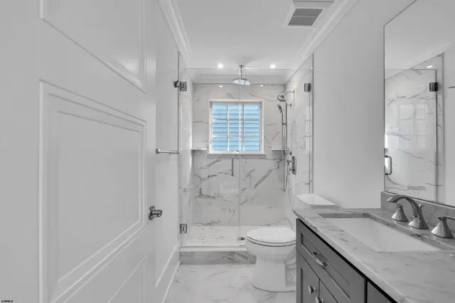 a large kitchen with stainless steel appliances granite countertop a lot of counter space and wooden floors