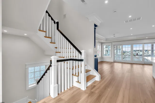 a large kitchen with stainless steel appliances granite countertop a lot of counter space and a wooden floor