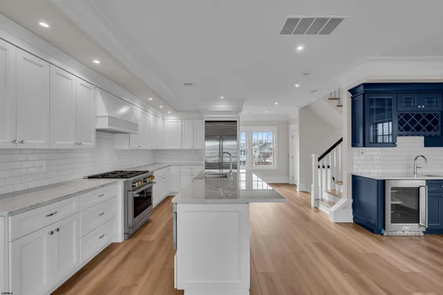 a kitchen with granite countertop a sink stove and cabinets