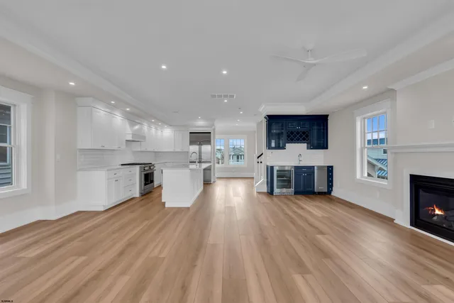 a kitchen with granite countertop a sink a stove and cabinets