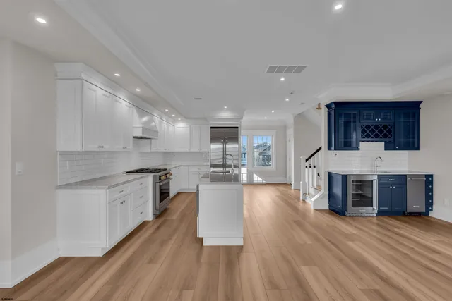 a kitchen with granite countertop a sink stainless steel appliances and cabinets