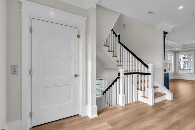 a view of entryway and hall with wooden floor
