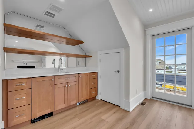 a view of a roof deck with couches and wooden floor