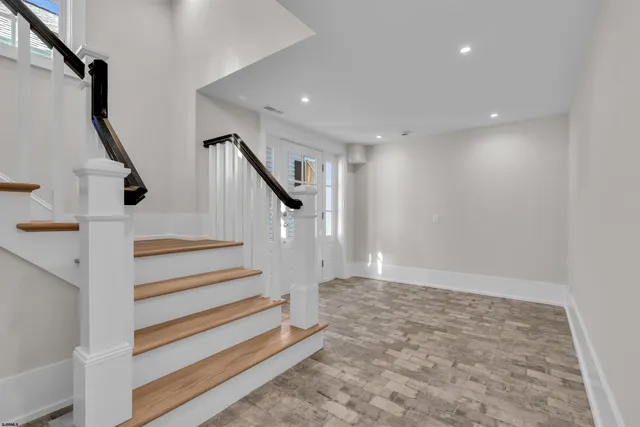 a view of wooden floor and windows in a room