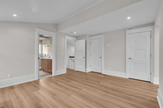 a bathroom with a granite countertop sink a toilet and shower
