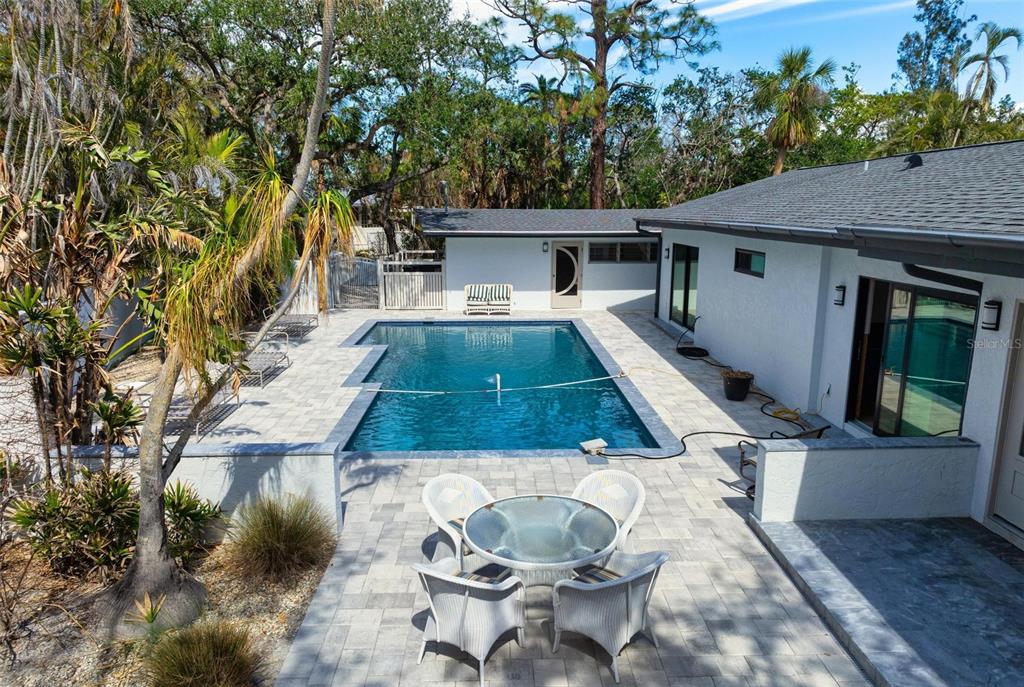 7345 Pine Needle Road Sarasota, FL 34242 - Photo 1 of 1 a view of a patio with chair and tables