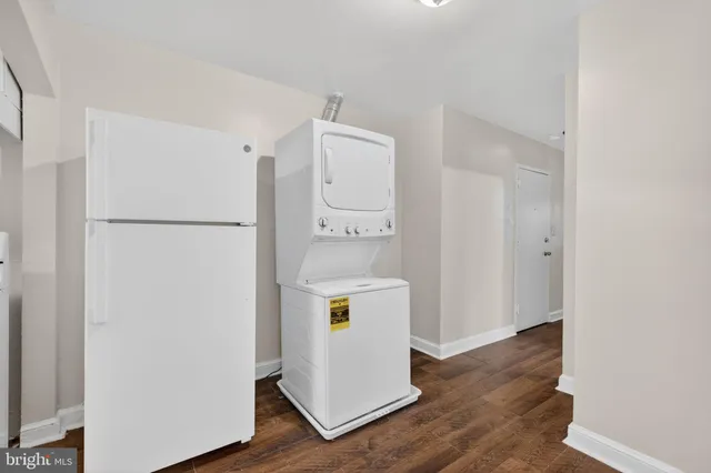 a view of walk in closet with wooden floor
