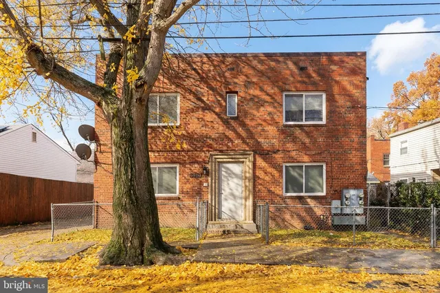 a view of a house with snow next to a road