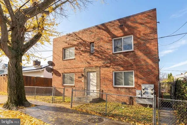 a backyard of a house with barbeque oven