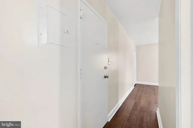 a view of a hallway with wooden floor