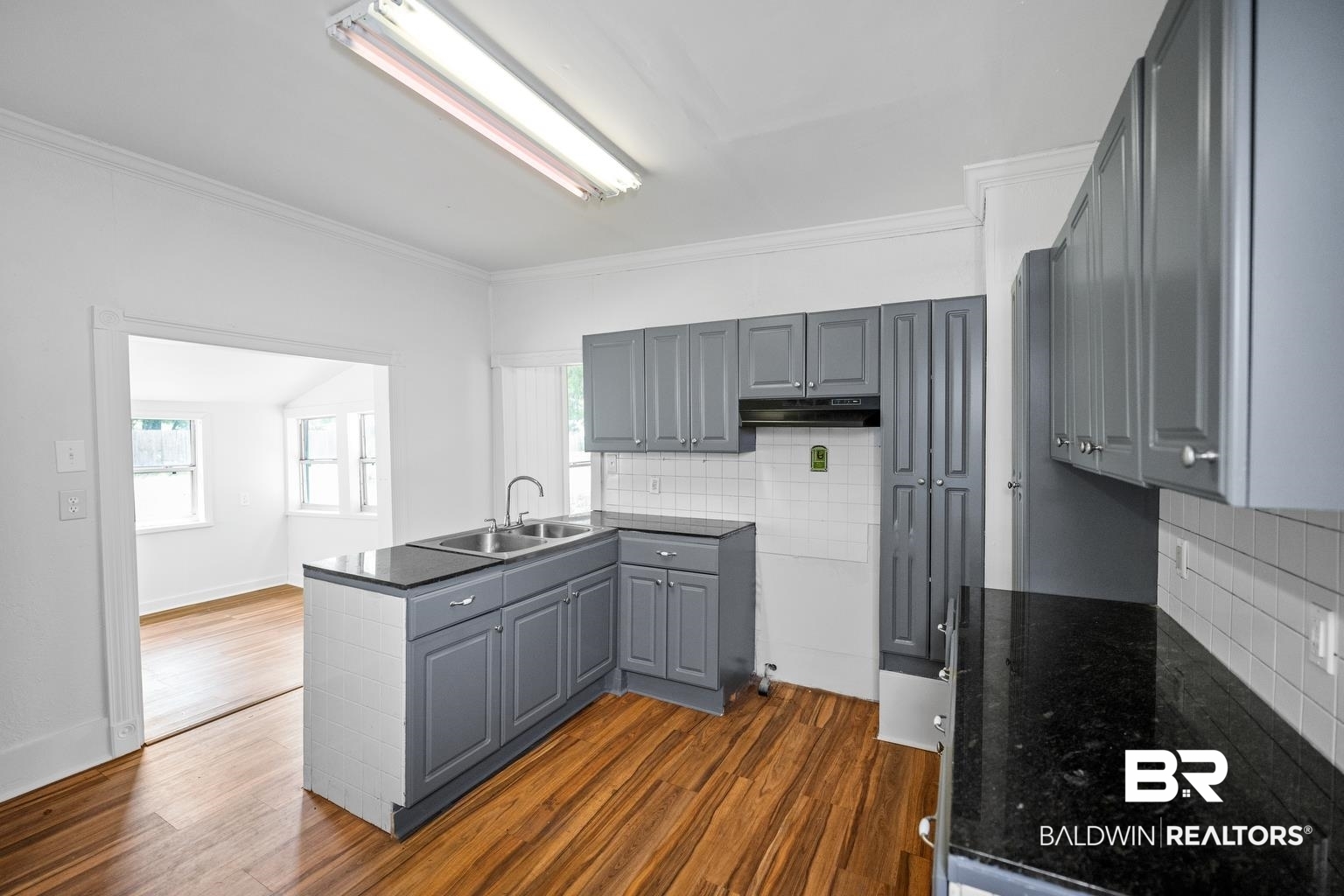 19575 Keller Road Foley, AL 36535 - Photo 11 of 17 Kitchen featuring gray cabinetry, decorative backsplash, plenty of natural light, a peninsula, and ornamental molding