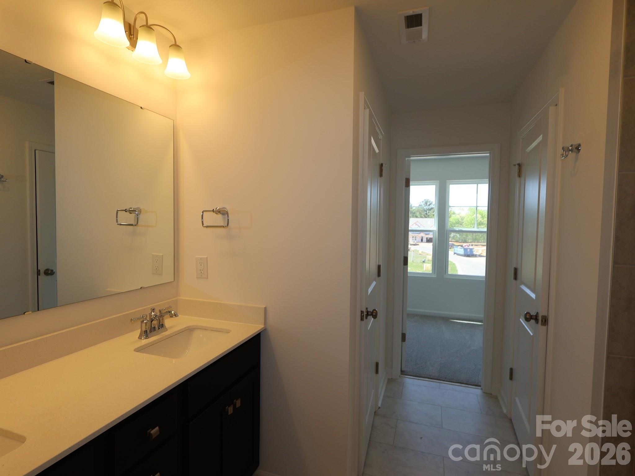 2015 Uplands Road Sherrills Ford, NC 28673 - Photo 11 of 19 a bathroom with a granite countertop sink shower and a mirror