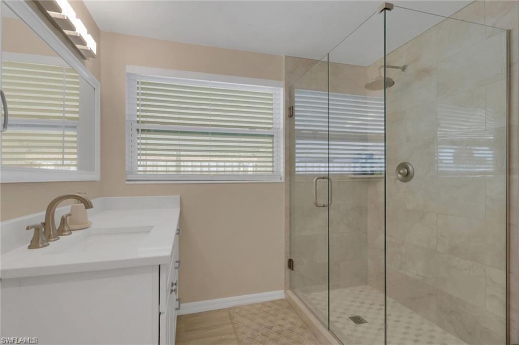 829 107th Avenue North Naples, FL 34108 - Photo 12 of 34 a bathroom with a sink and shower