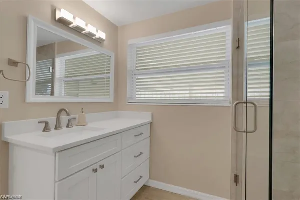 a bathroom with a sink a vanity and a mirror