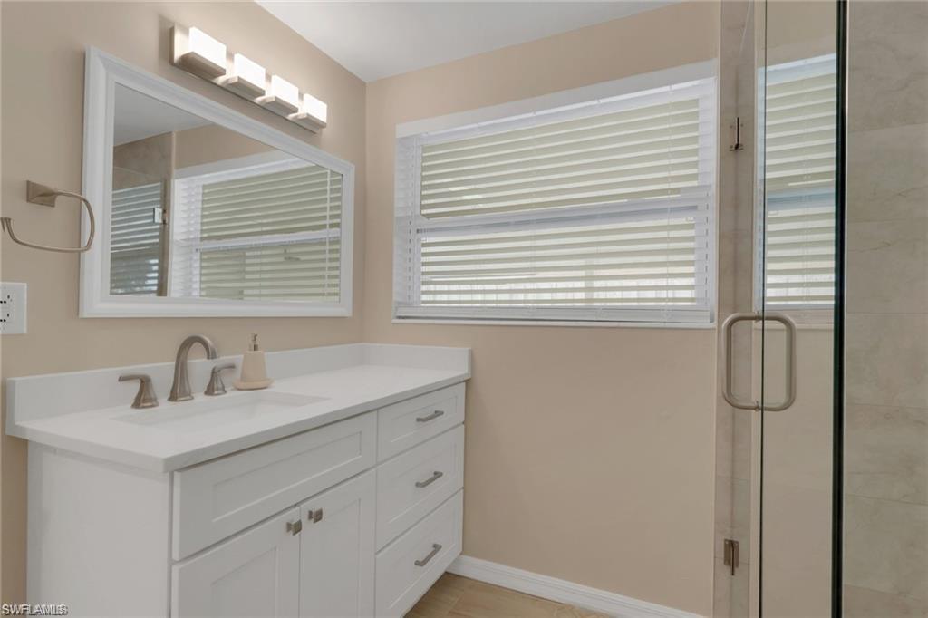 829 107th Avenue North Naples, FL 34108 - Photo 13 of 34 a bathroom with a sink a vanity and a mirror