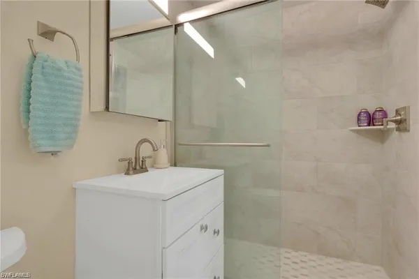a bathroom with a sink toilet and shower