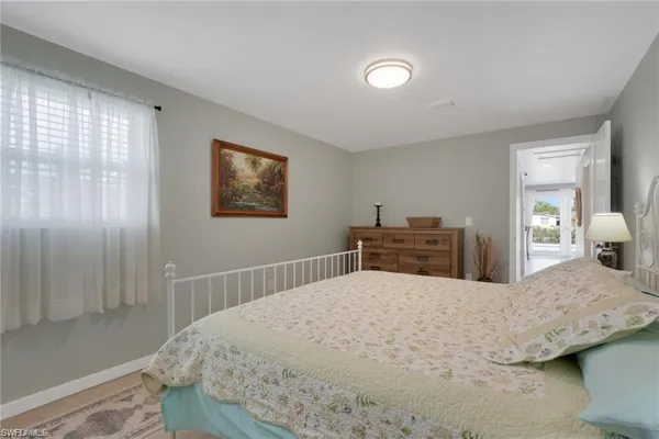 a bedroom with a large bed and a window