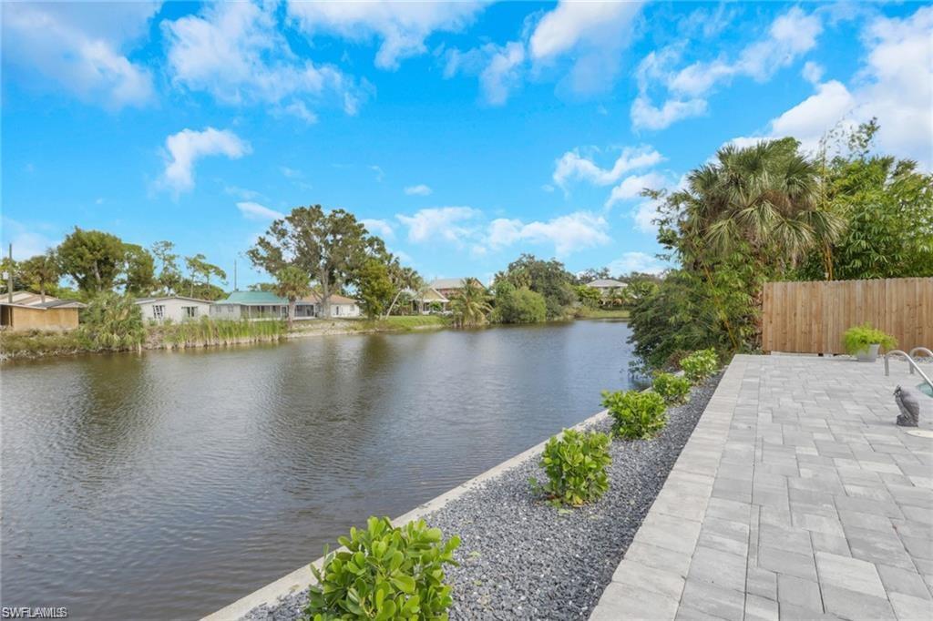 829 107th Avenue North Naples, FL 34108 - Photo 17 of 34 a view of a lake with a garden