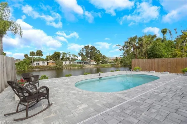a view of a swimming pool and lounge chairs