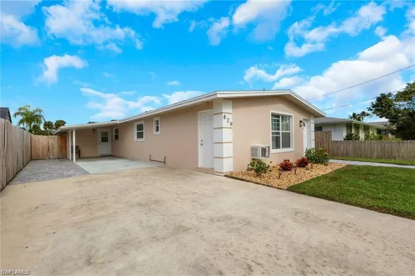 a view of a house with a yard and garage
