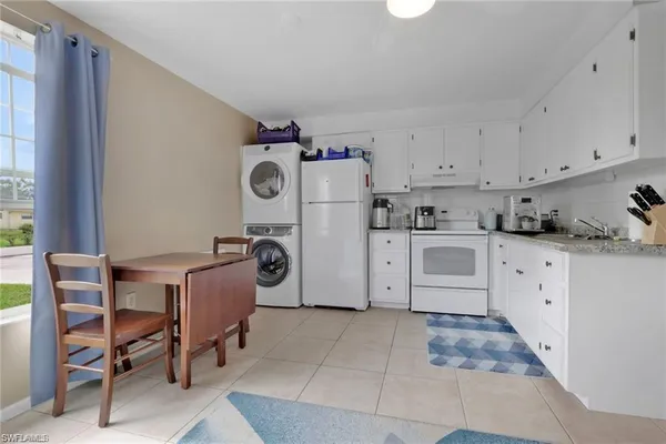 a kitchen with refrigerator and cabinets