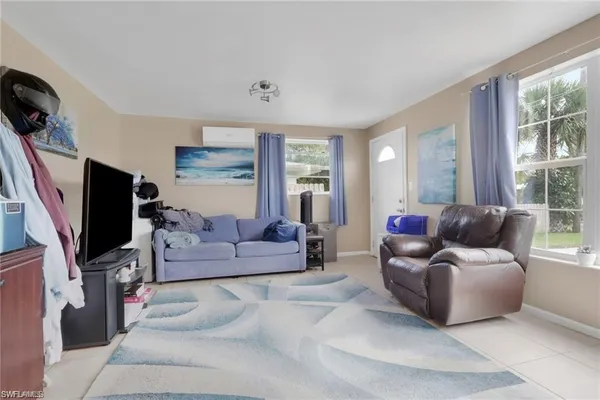 a living room with furniture and a flat screen tv