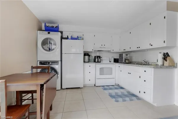 a kitchen with cabinets and window