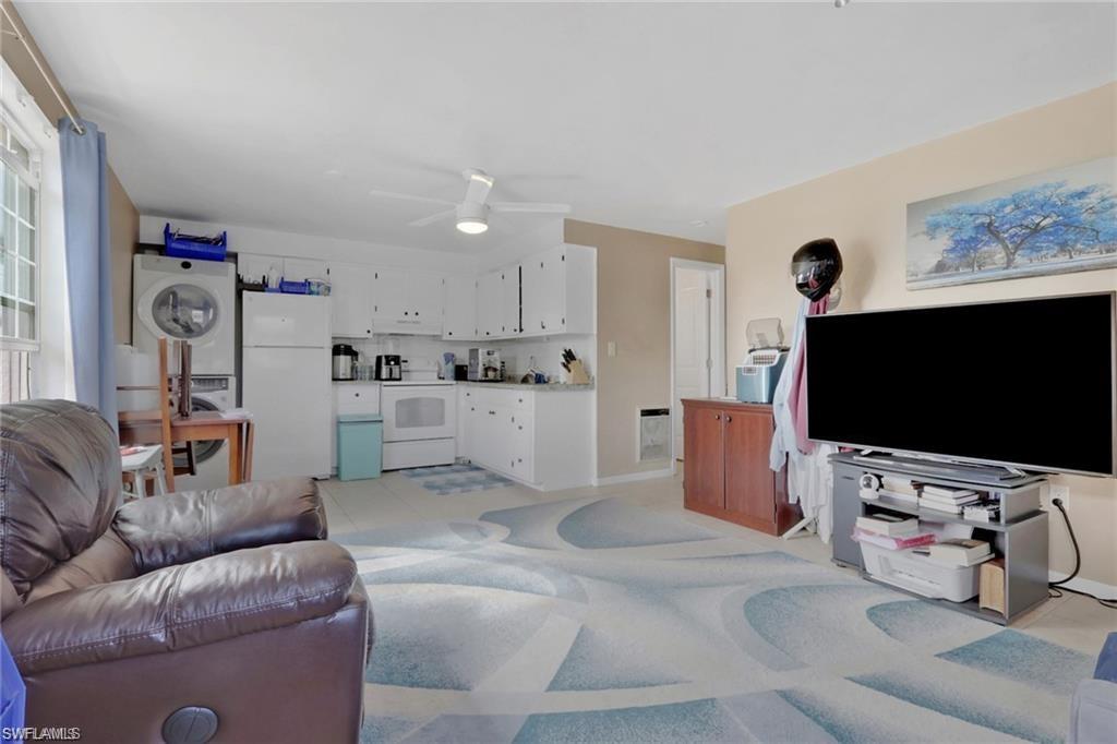 829 107th Avenue North Naples, FL 34108 - Photo 30 of 34 a living room with furniture and a flat screen tv